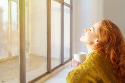 woman smiling at window