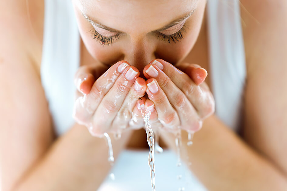 woman washing her face
